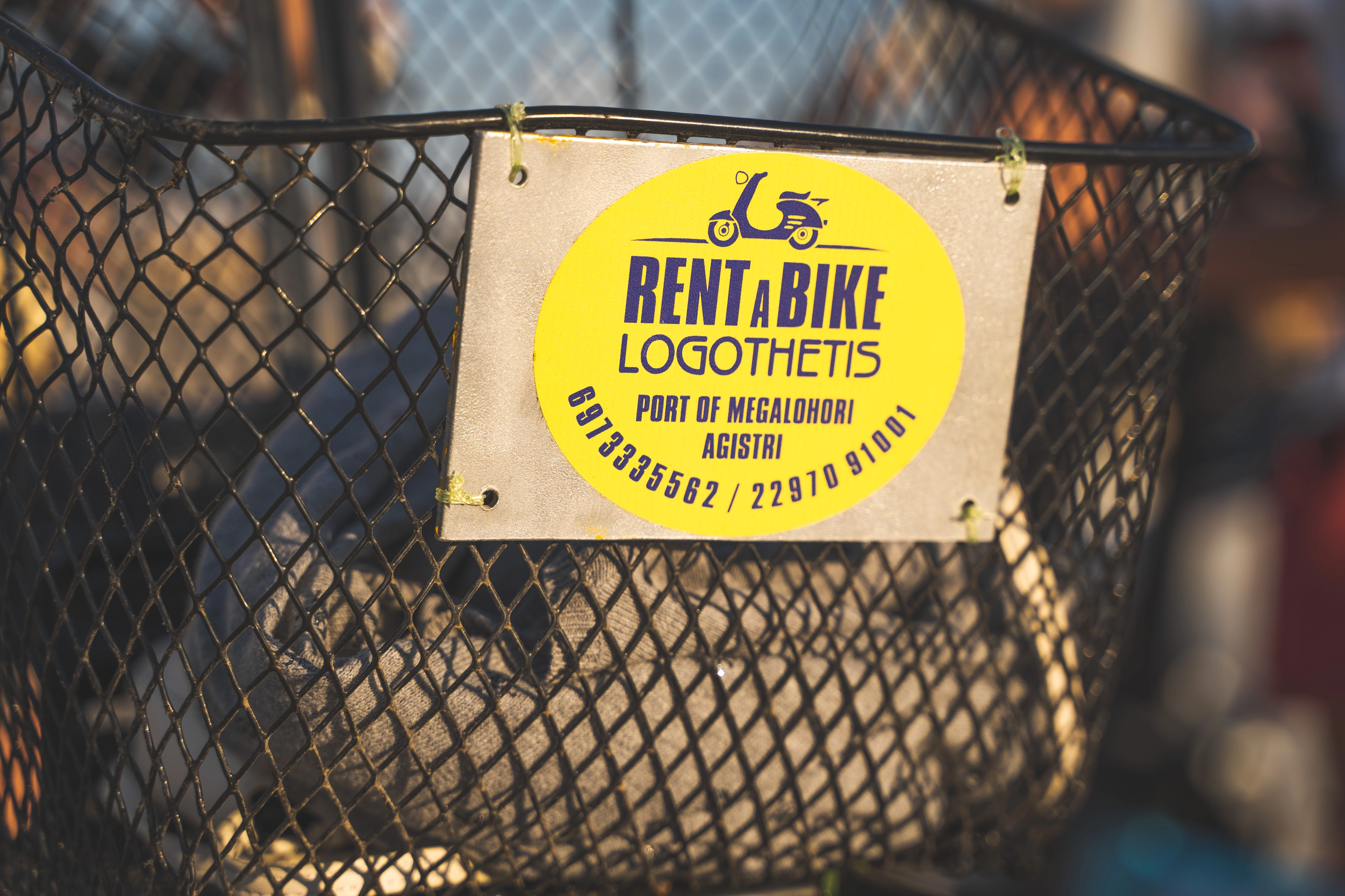 Logothetis rent a bike badge on a rental&s bike basket